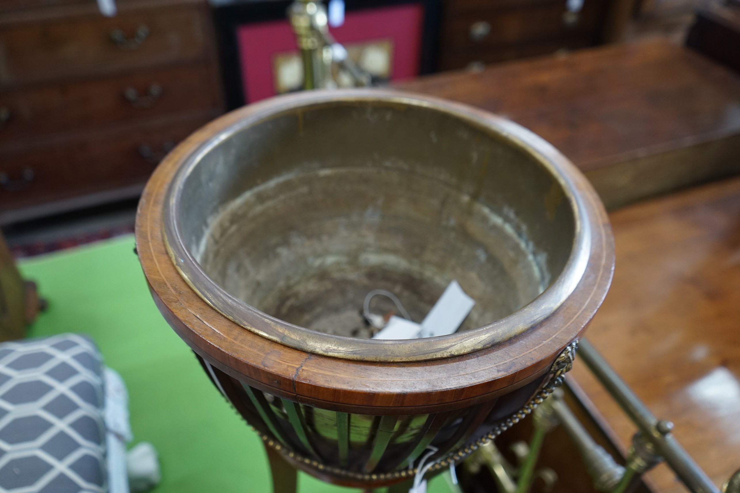 An Edwardian satinwood banded mahogany jardiniere with brass liner, diameter 35cm, height 85cm.